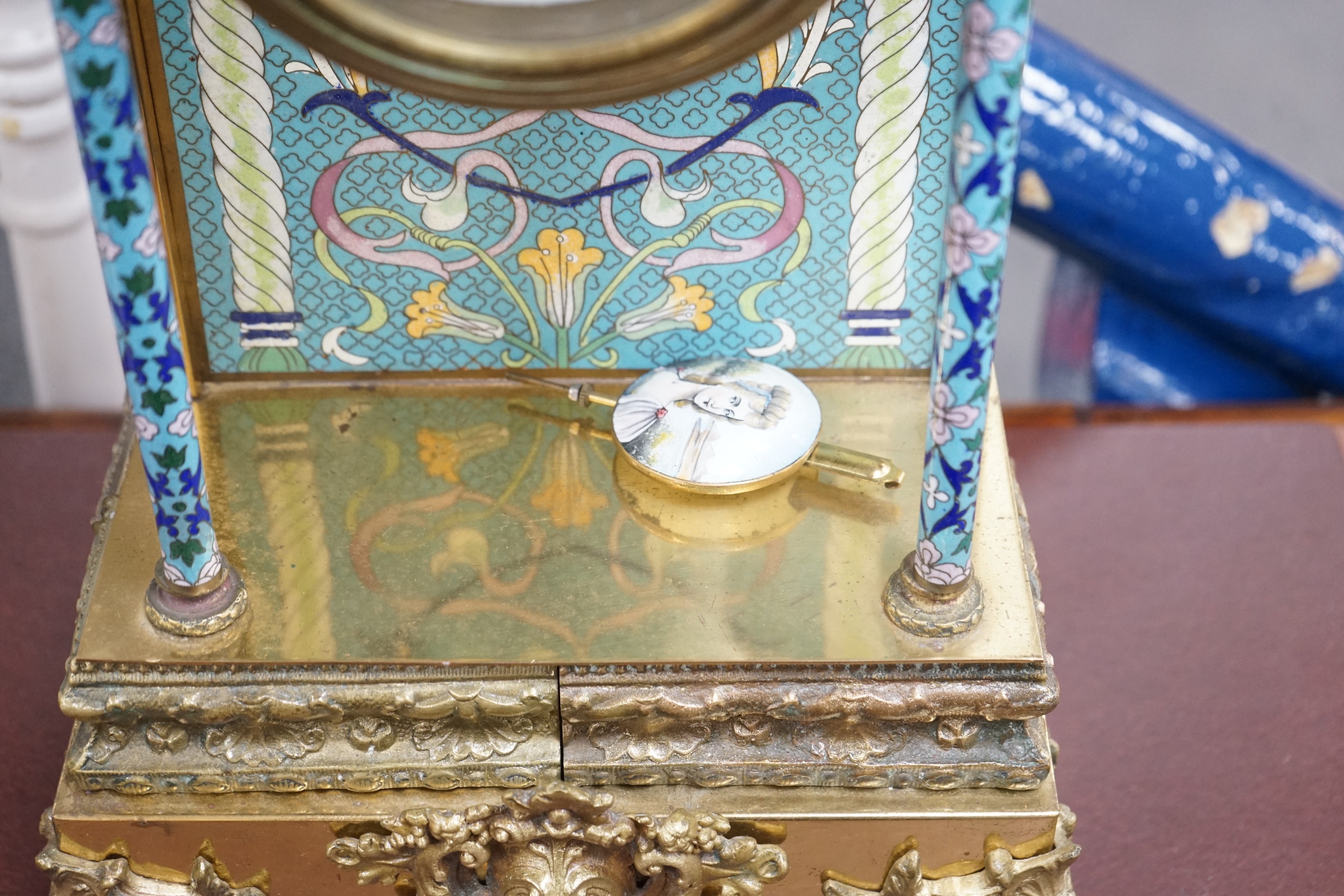 A large blue enamelled mantel clock with pendulum. 66cm tall